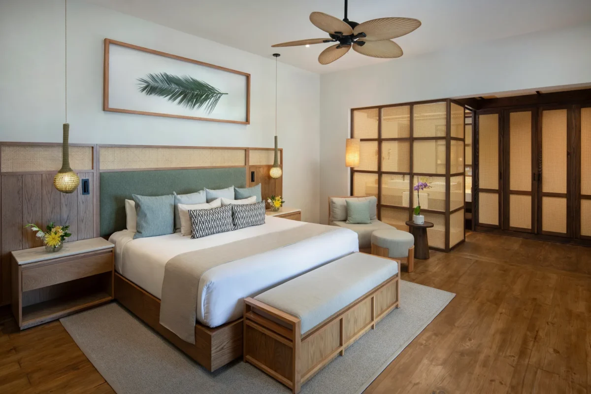 Junior Suite Deluxe Oceanfront king bedroom at Zoëtry Agua Punta Cana with private terrace access.