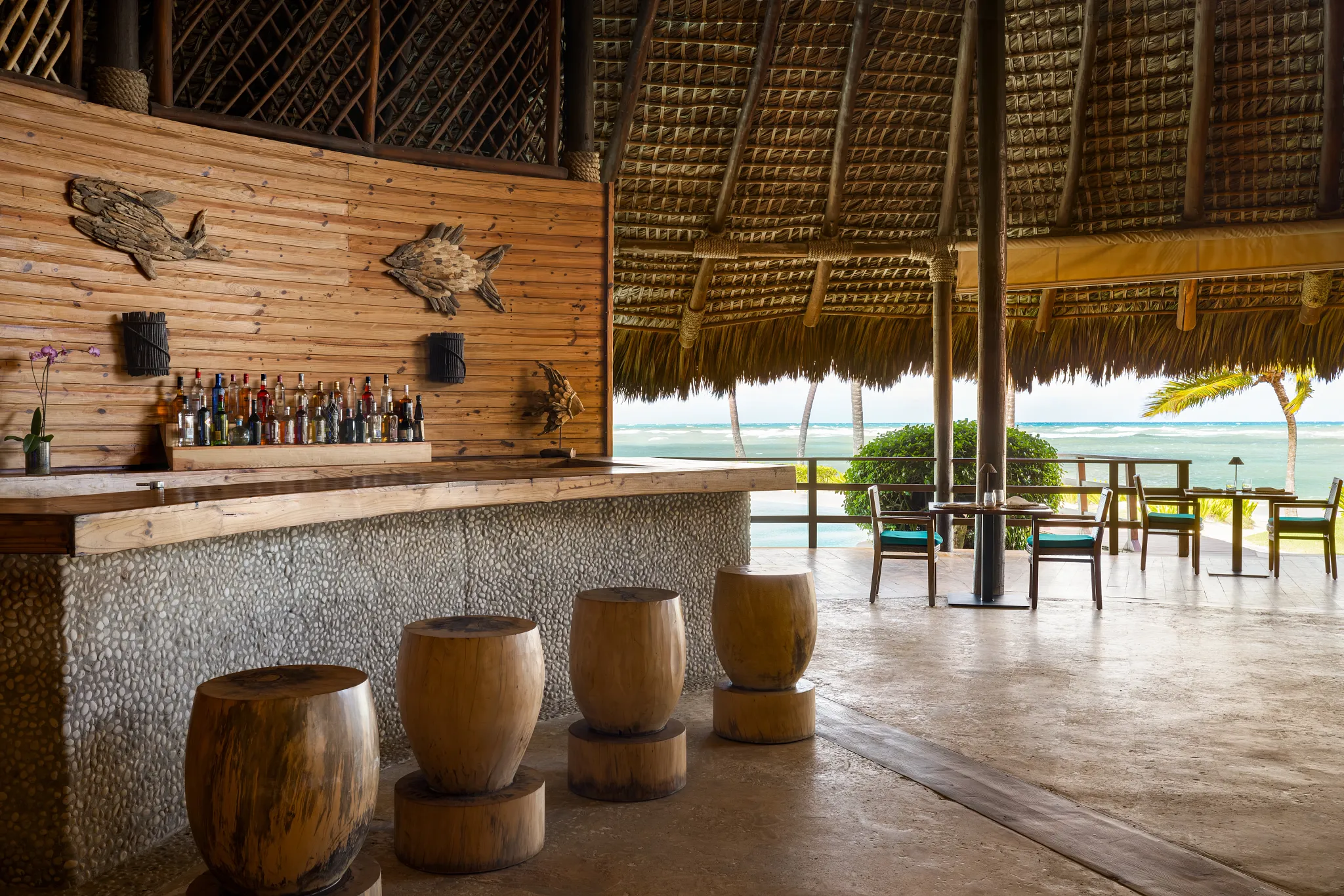 Indigo Bar at Zoëtry Agua Punta Cana featuring a beachfront palapa bar with ocean views and handcrafted tropical cocktails.