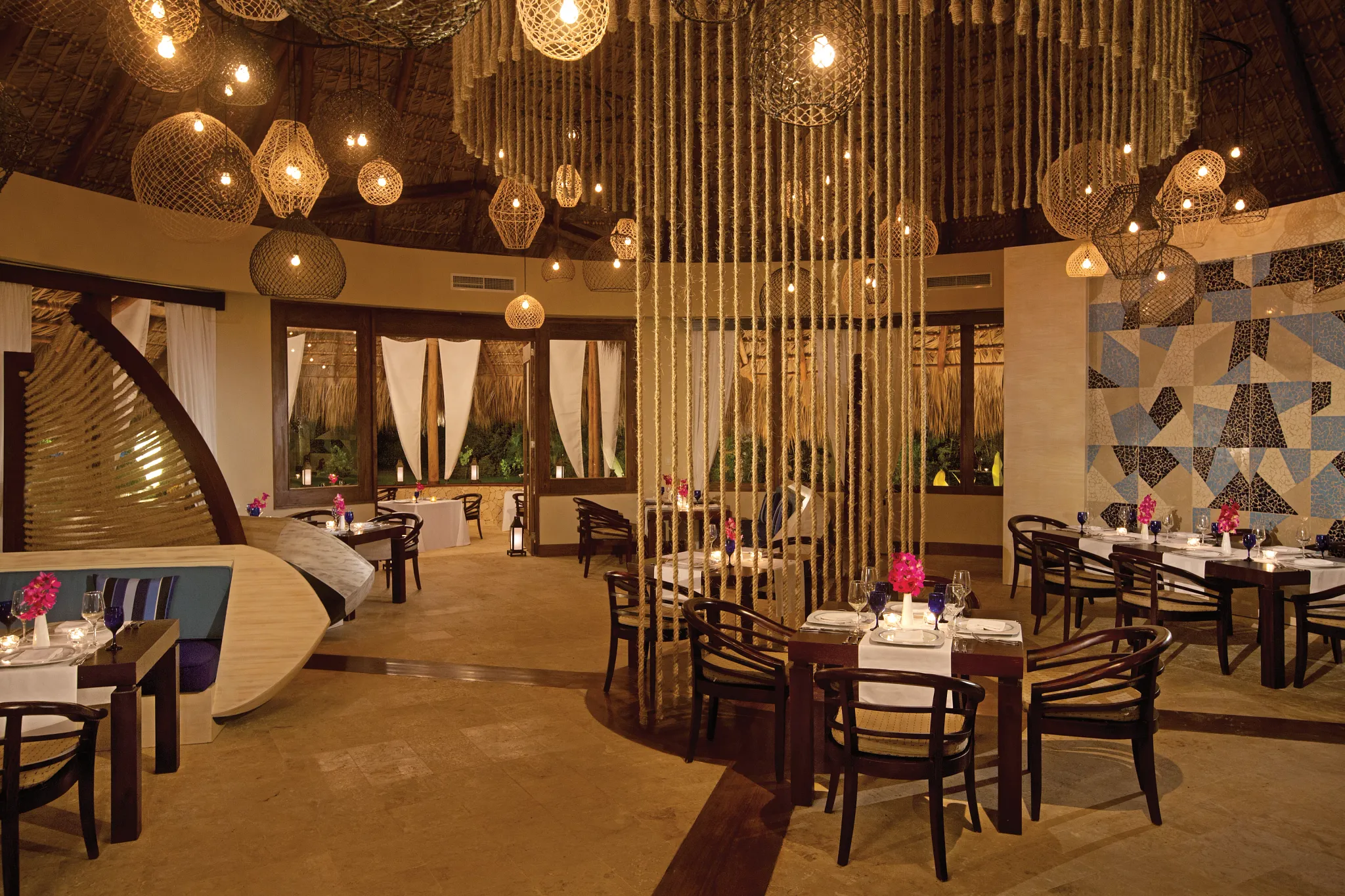 Piragua Restaurant at Zoëtry Agua Punta Cana featuring Caribbean-inspired décor, warm lantern lighting, and elegant tropical dining ambiance.
