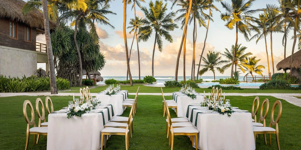 Villas Garden reception setup with banquet tables and palm trees at Zoetry Agua Punta Cana