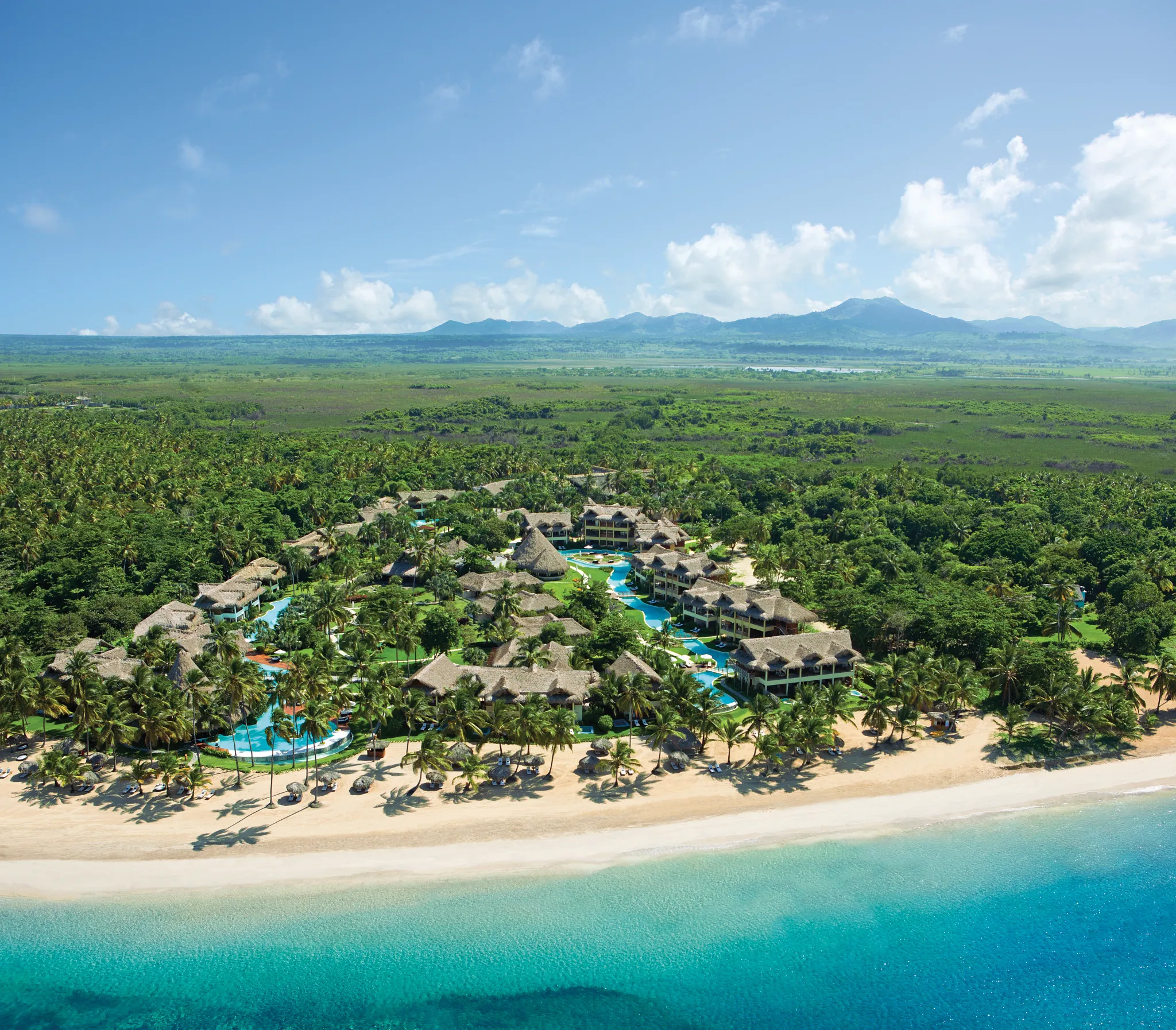 Aerial overview of Zoëtry Agua Punta Cana resort with pools, gardens, and white-sand beach.