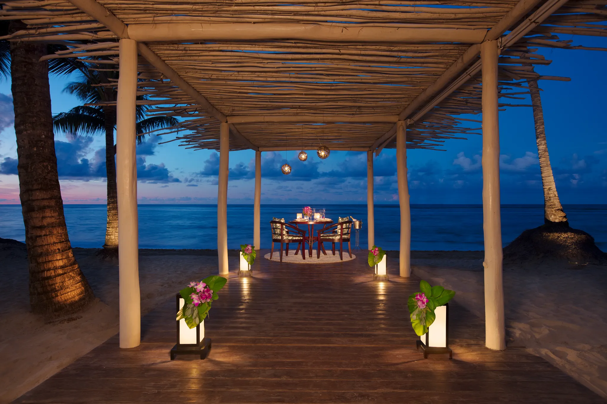 Private candlelit beach dinner under a pergola at Zoëtry Agua Punta Cana.